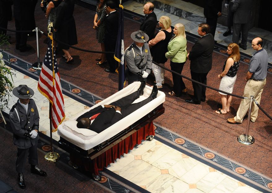 South Carolina Highway Patrol honor guards stand over Sen. Clementa Pinckney’s body as members of the public file past in the Statehouse, Wednesday, June 24, 2015, in Columbia, S.C.  President Barack Obama is scheduled to deliver the eulogy at Pinckney&#39;s funeral Friday morning at the College of Charleston. (AP Photo/Rainier Ehrhardt)