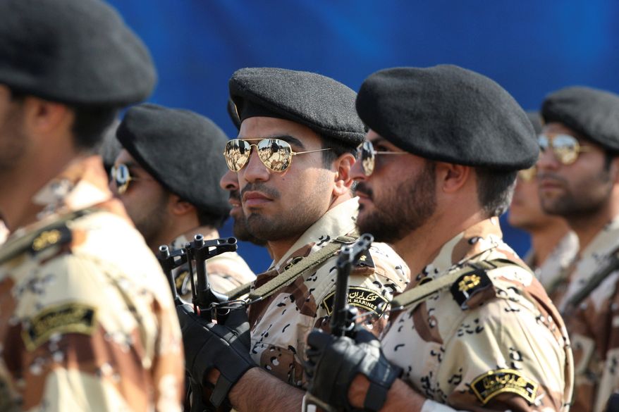 Members of Iran's Revolutionary Guard march in front of the mausoleum of late Iranian revolutionary founder Ayatollah Khomeini. (Associated Press) ** FILE **