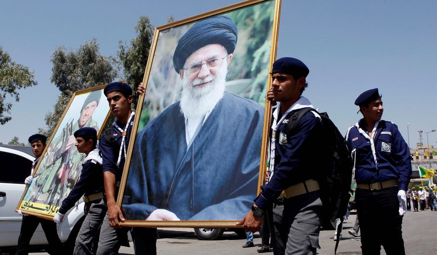 In a show of support, Iraqi Hezbollah scouts parade with a portrait of Iran&#x27;s supreme leader, Ayatollah Ali Khamenei. (Associated Press/File)