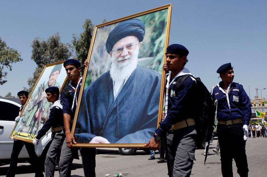 In a show of support, Iraqi Hezbollah scouts parade with a portrait of Iran&#x27;s supreme leader, Ayatollah Ali Khamenei. (Associated Press/File)