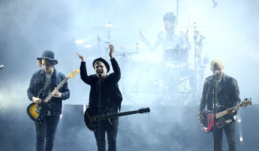 Joe Trohman, from left, Patrick Stump, Andy Hurley, on drums, and Pete Wentz of the musical group Fall Out Boy perform at the MTV Movie Awards at the Nokia Theatre on Sunday, April 12, 2015, in Los Angeles. (Photo by Matt Sayles/Invision/AP)