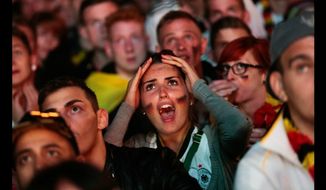German soccer fans watch a July 2014 World Cup match in Berlin. (Associated Press) ** FILE **