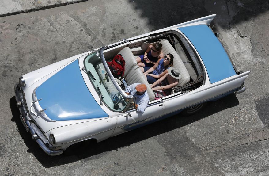 FILE - In this May 13, 2015, file photo, tourists ride a classic American convertible in Havana, Cuba. Caribbean tourism officials are pushing for a partnership with the U.S. government because of concerns that warming relations between the U.S. and Cuba will result in a significant loss of visitors to the rest of the region. Cuba has seen such a surge in visitors that the fragile budgets of many tourism-dependent islands will be hit hard if they don&#x27;t take action, Frank Comito, CEO of the Caribbean Hotel &amp;amp; Tourism Association, said Wednesday, June 24, 2015. (AP Photo/Desmond Boylan, File)