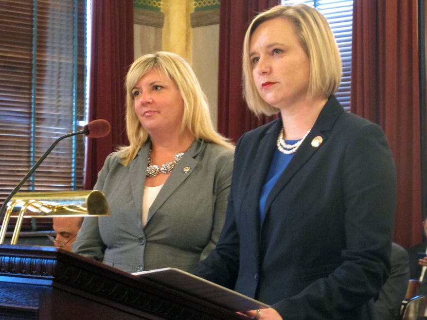 State Rep. Stephanie Kunze, left, and state Rep. Sarah LaTourette listen to an explanation of a minor change to their proposed legislation that extends the time for prosecuting rape and sexual battery to 25 years after the crime, on Wednesday, June 24, 2015, in Columbus, Ohio. The Senate Criminal Justice Committee approved the bill. (AP Photo/Andrew Welsh-Huggins)