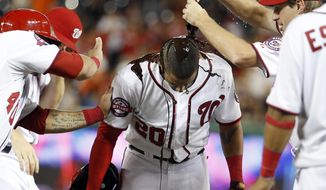 CORRECTS THAT DESMOND HIT SACRIFICE FLY, INSTEAD OF SINGLE - Washington Nationals&#39; Ian Desmond is doused with chocolate syrup by Max Scherzer, right, after a baseball game against the Atlanta Braves at Nationals Park, Wednesday, June 24, 2015, in Washington. Desmond hit a sacrifice fly to score the winning run. The Nationals won 2-1 in 11 innings. (AP Photo/Alex Brandon)