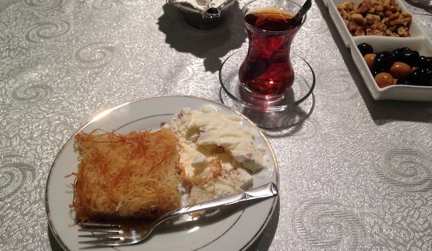 Turkish kadayif, a pastry dish similar to baklava, is offered as the dessert course of a traditional Muslim iftar, a fast-breaking meal served after sundown during the holy month of Ramadan, alongside cay, a tea drink. (By Emily Leslie/The Washington Times)