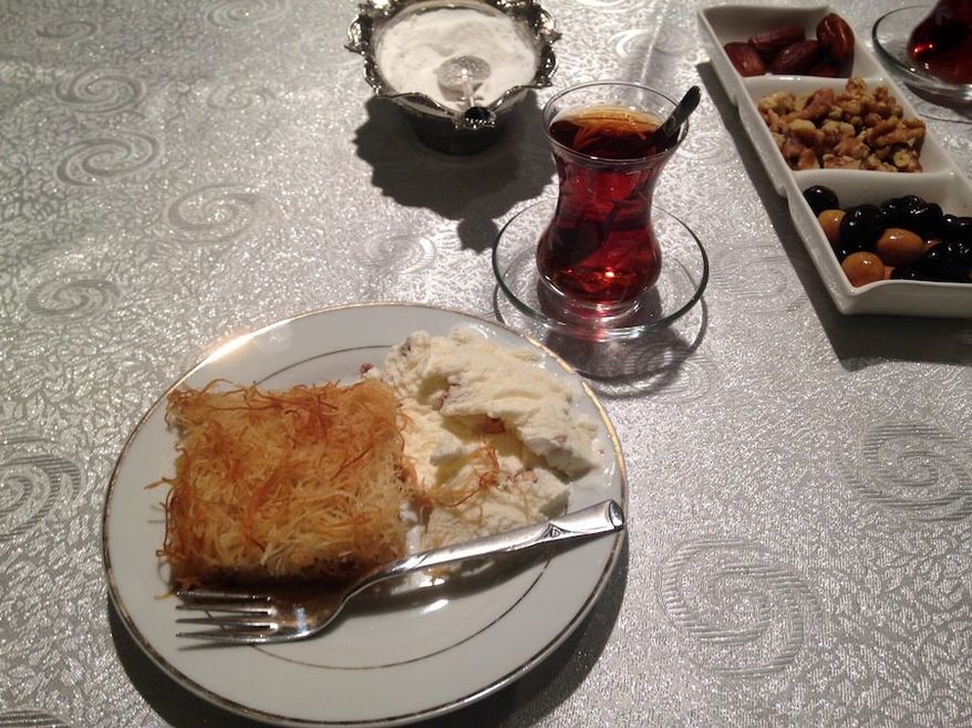 Turkish kadayif, a pastry dish similar to baklava, is offered as the dessert course of a traditional Muslim iftar, a fast-breaking meal served after sundown during the holy month of Ramadan, alongside cay, a tea drink. (By Emily Leslie/The Washington Times)