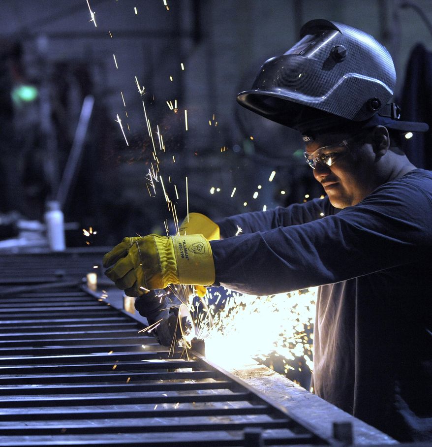 ADVANCED FOR RELEASE MONDAY, JUNE 29, 2015 Machinist Angel Altamirano, 32, of River Rouge, grinds a guardrail for a staircase, Thursday, June 11, 2015. (Todd McInturf /The Detroit News via AP)