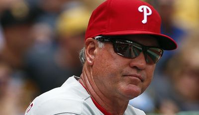 FILE - In this June 14, 2015, file photo, Philadelphia Phillies manager Ryne Sandberg stands in the dugout during a baseball game against the Pittsburgh Pirates in Pittsburgh. Sandberg resigned as manager of the baseball club on Friday, June 26, 2015. (AP Photo/Gene J. Puskar, File)