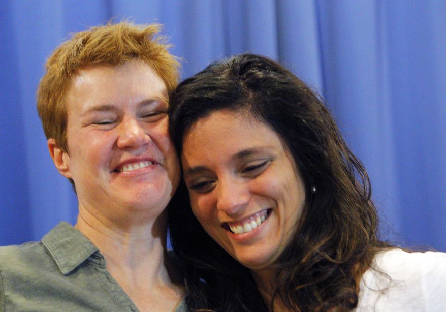 Val Tanco, right, and Sophie Jesty, plaintiffs in the Supreme Court case on gay marriage, smile during a news conference in Knoxville, Tenn. on Friday, June 26, 2015. Friday's Supreme Court ruling legalizes gay marriage nationwide, including in the 14 remaining states with bans. They moved to Tennessee for work after marrying in New York. (AP Photo/Wade Payne)