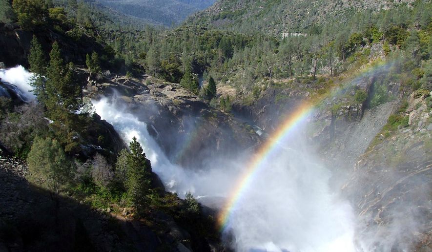 FILE - This May, 16, 2012 file photo shows a rainbow forming in the mist from water releases at Hetch Hetchy Reservoir on the Tuolomne River in Yosemite National Park, Calif. On Friday, June 26, 2015, regulators told San Francisco to stop taking some of the river water it routinely stores in the Hetch Hetchy reservoir — though it wasn't immediately clear what the practical effect would be. (John Holland/The Modesto Bee via AP, File)