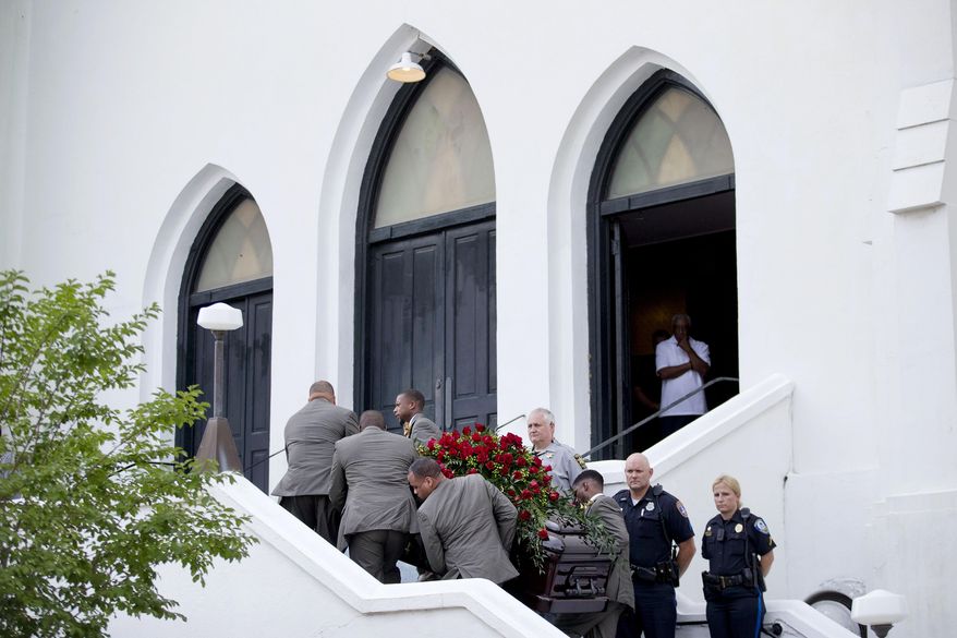 Pallbearers carry the casket of Sen. Clementa Pinckney, one of the nine killed in last week&#39;s shooting, into Emanuel AME Church for his wake, Thursday, June 25, 2015, in Charleston, S.C. President Barack Obama will deliver the eulogy at Pinckney&#39;s funeral Friday at a nearby college arena. (AP Photo/David Goldman)