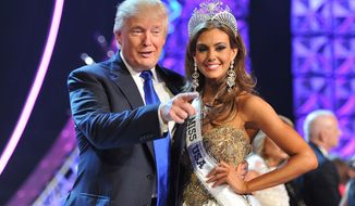 FILE - In this June 16, 2013 file photo, Donald Trump, left, and Miss Connecticut USA Erin Brady pose onstage after Brady won the 2013 Miss USA pageant in Las Vegas, Nev. Univision says it is dropping the Miss USA Pageant and says it will cut all business ties with Donald Trump over comments he made about Mexican immigrants. The network said Thursday, June 25, 2015, it will not air the pageant on July 12, as previously scheduled, and has ended its business relationship with the Miss Universe Organization due to what it called &amp;quot;insulting remarks about Mexican immigrants&amp;quot; by Trump, a part owner. (AP Photo/Jeff Bottari, File)