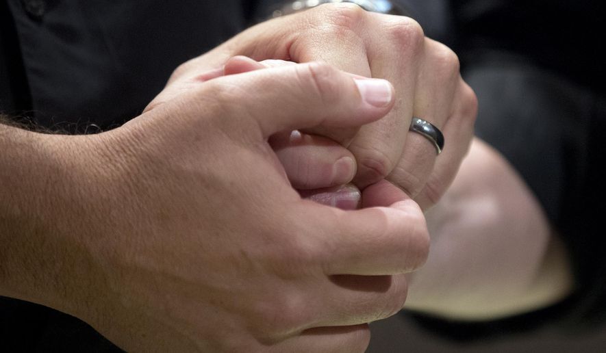 Ed Cieslak and Richard Moye hold hands as they are married in a mass wedding at the Fulton County Government Center Friday, June 26, 2015, in Atlanta. A court in Atlanta started marrying gay couples Friday after the U.S. Supreme Court struck down Georgia&#39;s ban on same-sex marriage. (AP Photo/John Bazemore) **FILE**