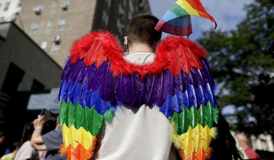 A demonstrator arrives at a rally in Greenwich Village to celebrate the Supreme Court&#x27;s ruling on gay marriage, Friday, June 26, 2015, in New York. The Supreme Court declared that same-sex couples have a right to marry anywhere in the U.S.  (AP Photo/Julie Jacobson) ** FILE **