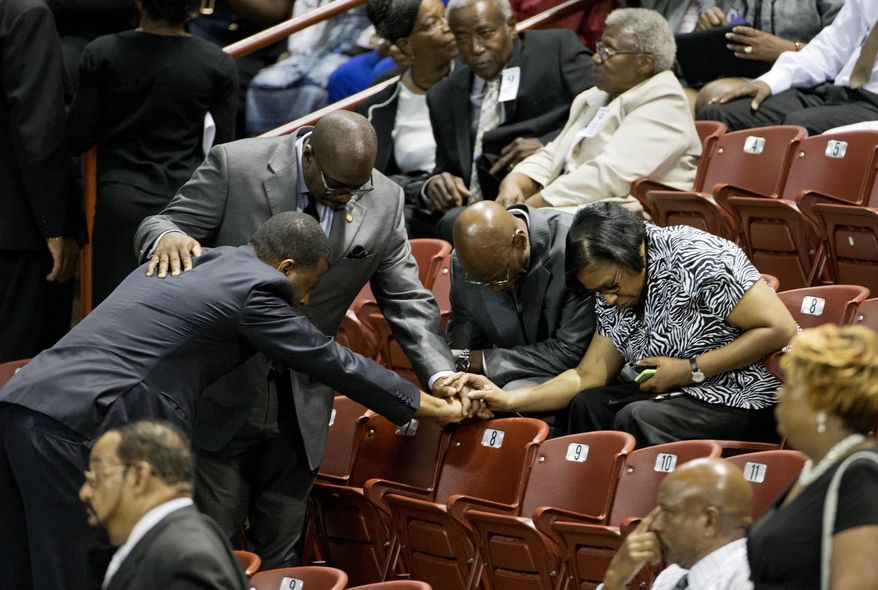 Mourners pray before the funeral service for Sen. Clementa Pinckney, Friday, June 26, 2015, in Charleston, S.C. President Barack Obama will deliver the eulogy at Pinckney&#39;s funeral Friday at College of Charleston&#39;s TD Arena  near the Emanuel AME Church, the scene of last week&#39;s shooting. (AP Photo/David Goldman)