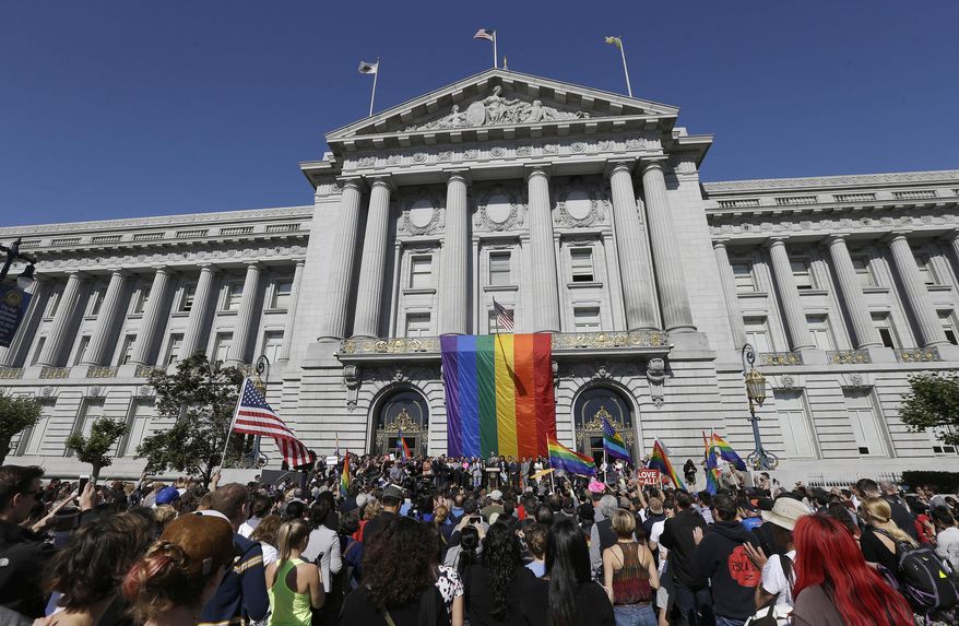FILE - In this June 26, 2015, file photo, a crowd gathers as San Francisco Mayor Ed Lee speaks at a news conference outside of City Hall in San Francisco, after the U.S. Supreme Court ruled that  same-sex couples have the right to marry nationwide. Rainbows and good cheer will be out in force this weekend as hundreds of thousands of people pack gay pride events from New York to Seattle, San Francisco to Chicago to celebrate the Supreme Court ruling legalizing same-sex marriage. (AP Photo/Jeff Chiu, File)