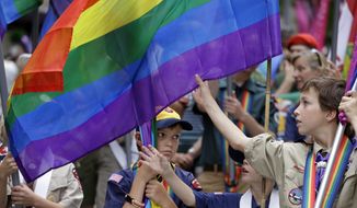 Scouts prepare their flags before leading marchers in the 41st annual Pride Parade Sunday, June 28, 2015, in Seattle. A large turnout was expected for gay pride parades across the U.S. following the landmark Supreme Court ruling that said gay couples can marry anywhere in the country. (AP Photo/Elaine Thompson)
