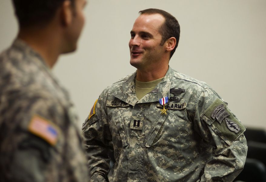 In this Jan. 4, 2011, file photo, U.S Army Capt. Mathew Golsteyn, right, is congratulated by fellow soldiers following the Valor Awards ceremony for 3rd Special Forces Group at Fort Bragg, N.C. (James Robinson/The Fayetteville Observer via AP) ** FILE **