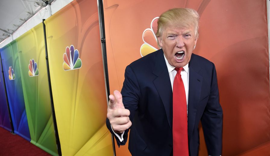 Donald Trump, host of the television series &quot;The Celebrity Apprentice,&quot; mugs for photographers at the NBC 2015 Winter TCA Press Tour in Pasadena, Calif., on Jan. 16, 2015. (Chris Pizzello/Invision/Associated Press) ** FILE **