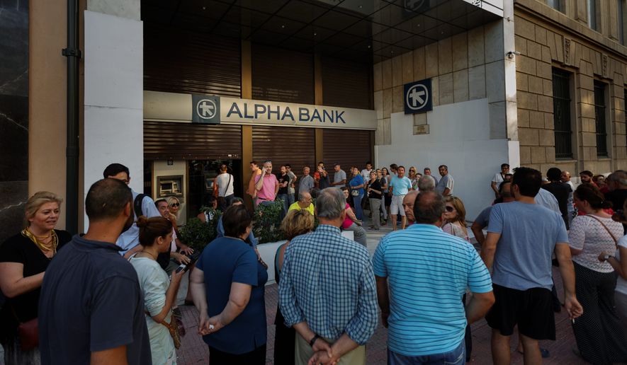 Anxious Greeks lined up at ATMs on Monday as they gradually began dispensing cash again on the first day of capital controls imposed in a dramatic twist in Greece&#39;s financial saga. Banks will remain shut until next Monday, and a daily limit of $67 has been placed on cash withdrawals from ATMs. (Associated Press)
