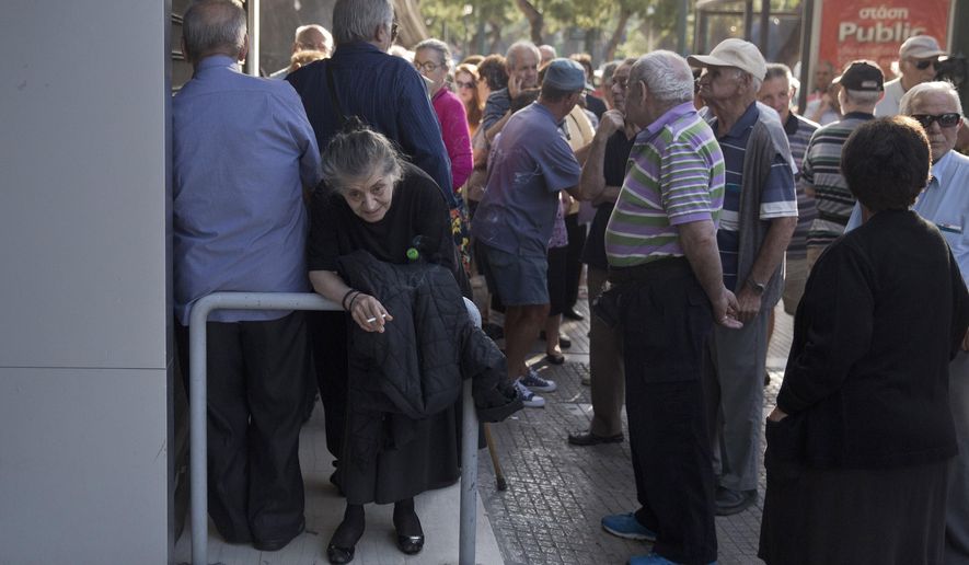 Elderly people, who usually get their pensions at the end of the month, wait outside a closed bank in Athens, Monday, June 29, 2015. Greece&#x27;s five-year financial crisis took its most dramatic turn yet, with the cabinet deciding that Greek banks would remain shut for six business days and restrictions would be imposed on cash withdrawals. (AP Photo/Petros Giannakouris)