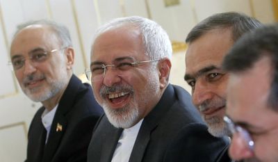 Iranian Foreign Minister Javad Zarif laughs during a meeting with U.S. Secretary of State John Kerry at a hotel in Vienna, Austria, Tuesday, June 30, 2015. (Carlos Barria/Pool via AP) ** FILE **