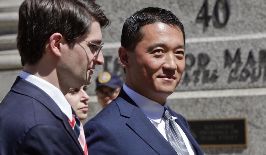 In this June 24, 2015 photo, Benjamin Wey, right, CEO of New York Global Group, leaves Manhattan Federal Court in New York. Hanna Bouveng sued her former Wall Street executive boss, Wey, over lurid allegations of sexual conquest, betrayal and stalking was awarded about $18 million by a federal jury Monday, June 29, 2015. (AP Photo/Frank Franklin II)