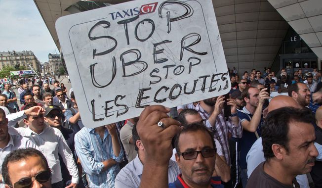French taxi drivers protested, and authorities took two Uber managers into custody for questioning last week over &quot;illicit activity&quot; involving the low-cost ride-hailing service. (Associated Press)