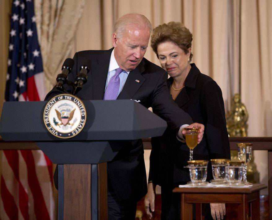 Brazilian President Dilma Rousseff watches as Vice President Joe Biden puts his glass on a table after a toast during a luncheon in her honor, Tuesday, June 30, 2015, at the State Department in Washington.    (AP Photo/Manuel Balce Ceneta)