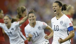 Carli Lloyd (10) of the U.S. Women&#39;s National Soccer Team celebrates with teammates Ali Krieger (11) and Morgan Brian after scoring on a penalty kick against Germany during the second half of Tuesday&#39;s World Cup semifinal in Montreal, Canada. (Associated Press)
