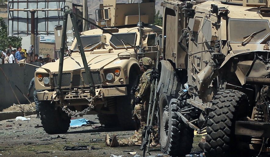 Armored vehicles remain at the site of a blast targeting the NATO convoy in Kabul, Afghanistan, Tuesday, June 30, 2015. It comes a week after an audacious attack on the nation&#39;s parliament, which highlighted the ability of insurgents, who have been fighting to overthrow the Kabul government for almost 14 years, to enter the highly fortified capital to stage deadly attacks. (AP Photo/Massoud Hossasini)