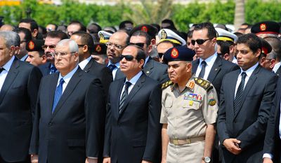 In this picture provided by the office of the Egyptian Presidency, Egyptian president Abdel-Fattah el-Sissi, center front, Minister of Defense Sedki Sobhi, center right and former acting Egyptian president Adly Mansour, second left, attend the military funeral of Hisham Barakat  the top judicial official in charge of overseeing the prosecution of thousands of Islamists, including former President Mohammed Morsi in Cairo, Egypt, Tuesday, June 30, 2015.  (Egyptian Presidency via AP)