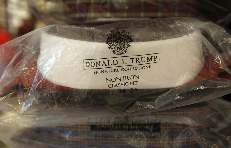 A Donald Trump menswear collection dress shirt is shown as part of a display of heavily discounted shirts at Macy's Herald Square flagship store, Wednesday, July 1, 2015, in New York. Macy's became the latest company to end its relationship with presidential candidate Trump after his remarks about Mexican immigrants. (AP Photo/Kathy Willens) ** FILE **