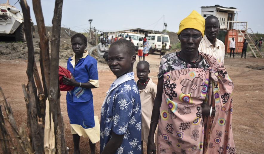 In this photo taken Friday, June 26, 2015, a displaced family arrives at the UN base in Bentiu, South Sudan. South Sudan’s army has burned people alive, raped and shot girls, and forced tens of thousands from their homes, according to interviews with survivors by The Associated Press and corroborated by human rights groups. (AP Photo/Jason Patinkin)