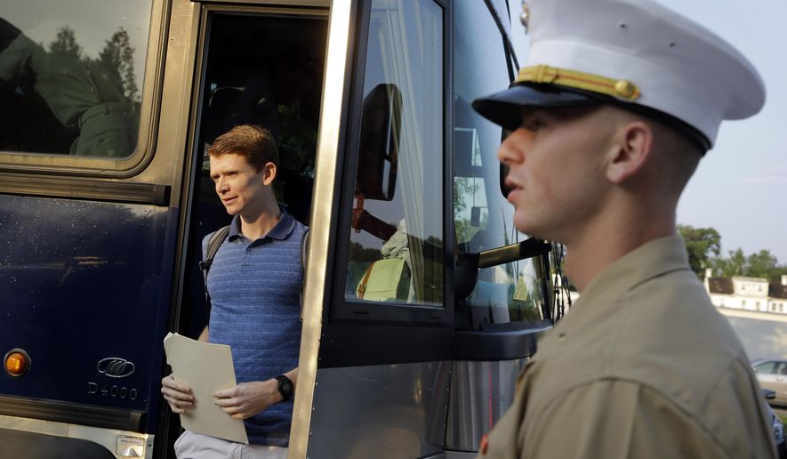 A prospective plebe steps off of a bus as he arrives at Induction Day at the U.S. Naval Academy, Wednesday, July 1, 2015, in Annapolis, Md. More than 1,100 young men and women reported for "I-Day," where they received haircuts, medical examinations, new uniforms and instructions on how to salute and address superiors before taking an oath of office to become members of academy's newest class. (AP Photo/Patrick Semansky)