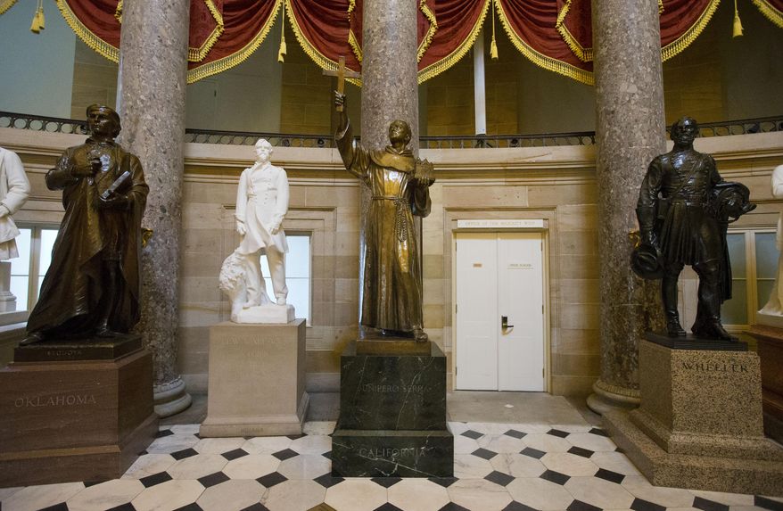 The statue of missionary Junipero Serra, center, is seen in Statuary Hall, also known as the Old Hall of the House, on Capitol Hill in Washington, Thursday, July 2, 2015. California lawmakers are shelving a plan to replace the statue with astronaut Sally Ride, bowing to pressure to drop the idea until after Pope Francis's September visit to the U.S., when he plans to make the 18th century missionary a saint. (AP Photo/Pablo Martinez Monsivais)