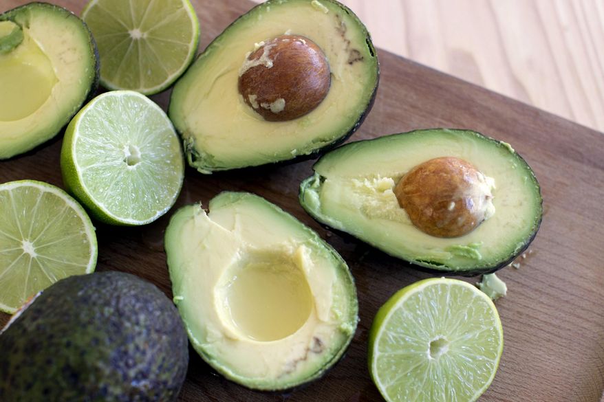 FILE - This Dec. 15, 2014 photo shows avocados and limes, key ingredients for guacamole in Concord, N.H. A New York Times article Wednesday, July 1, urged readers to pair peas with guacamole, causing an outrage on Twitter. Even President Barack Obama joined the online cacophony, tweeting out: “respect the nyt, but not buying peas in guac.” (AP Photo/Matthew Mead, File)