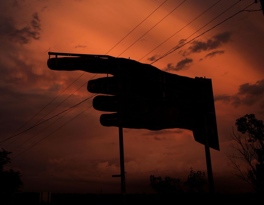 A billboard is silhouetted against storm clouds after a thunderstorm passed though the area Wednesday, July 1, 2015, in Higgensville, Mo. (AP Photo/Charlie Riedel)