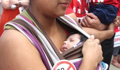 Angelica Saldivar, with her 3-week-old son, Andrew, was among the protesters of California legislation requiring childhood vaccinations. (Associated Press)