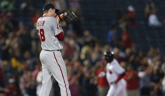 Washington Nationals starting pitcher Doug Fister (58) wipes his face as Atlanta Braves third baseman Juan Uribe (2) rounds the bases after hitting a home run in the fourth inning of a baseball game Wednesday, July 1, 2015, in Atlanta. Fister allowed two homer in the inning. (AP Photo/John Bazemore)