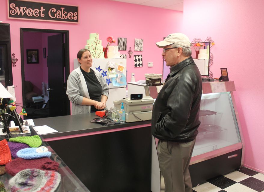 Melissa Klein, co-owner of Sweet Cakes by Melissa in Gresham, Oregon, tells a customer that the bakery has sold out of baked goods to sell for the day on Feb. 5, 2013. (Associated Press) ** FILE **