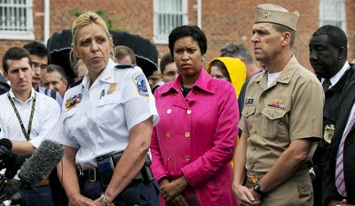 Washington Police Chief Cathy Lanier, left, with Washington Mayor Muriel Bowser, center, and Vice Admiral Dixon Smith, head of Navy Installations Command, speaks to the media during a news conference about the Navy Yard, Thursday, July 2, 2015, in Washington. (AP Photo/Jacquelyn Martin)