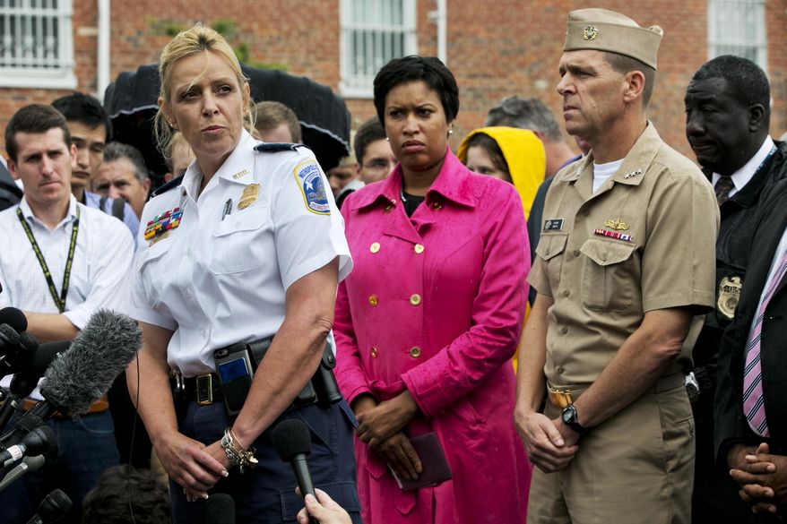 Washington Police Chief Cathy Lanier, left, with Washington Mayor Muriel Bowser, center, and Vice Admiral Dixon Smith, head of Navy Installations Command, speaks to the media during a news conference about the Navy Yard, Thursday, July 2, 2015, in Washington. (AP Photo/Jacquelyn Martin)