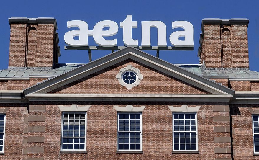 FILE - In this Tuesday, Aug. 19, 2014, file photo, a sign for Aetna Inc., sits atop a building at the company headquarters in in Hartford, Conn. Health insurer Aetna Inc. has made a deal to buy competitor Humana Inc. in a $37 billion deal the companies say would create the second-largest managed care company, it was announced Friday, July 3, 2014. (AP Photo/Jessica Hill, File)