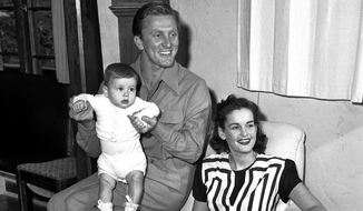 In this Sept. 9, 1947, file photo, actors Kirk and Diana Douglas pose with their second son, Joel, for his first portrait in the Hollywood district of Los Angeles. Diana Douglas, the first wife of Kirk Douglas and mother of Michael Douglas, has died in Los Angeles. She was 92. (AP Photo, File)