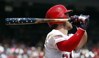 Washington Nationals&#39; Bryce Harper (34) watches his two-run homer as he holds his Independence Day themed bat during the first inning of a baseball game against the San Francisco Giants at Nationals Park, Saturday, July 4, 2015, in Washington. (AP Photo/Alex Brandon)
