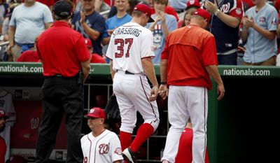 Washington Nationals starting pitcher Stephen Strasburg (37) walks with pitching coach Steve McCatty, right, to the clubhouse after he was relieved during the fourth inning of a baseball game against the San Francisco Giants at Nationals Park, Saturday, July 4, 2015, in Washington. (AP Photo/Alex Brandon)