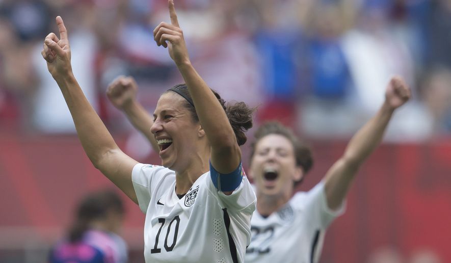 Carli Lloyd (left) of the U.S. Women&#39;s National Soccer Team celebrates a goal with Meghan Klingenberg during the first half of the FIFA Women&#39;s World Cup Final on Sunday against Japan in Vancouver, British Columbia, Canada. (The Canadian Press via Associated Press)