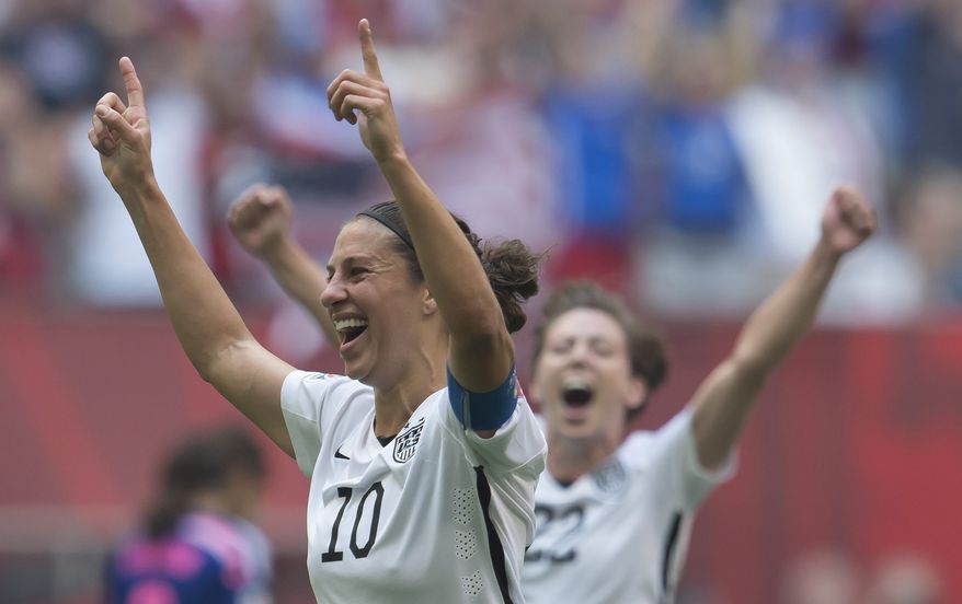 Carli Lloyd (left) of the U.S. Women&#x27;s National Soccer Team celebrates a goal with Meghan Klingenberg during the first half of the FIFA Women&#x27;s World Cup Final on Sunday against Japan in Vancouver, British Columbia, Canada. (The Canadian Press via Associated Press)